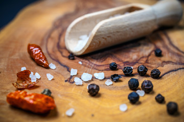 Chili with black pepper and salt on rustic wooden table. Overhead view food photography.