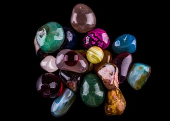Collection of Colorful Semiprecious Gemstones on Black Background.
