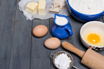 Ingredients for baking yeast cake, wooden background.