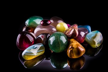 Collection of Colorful Semiprecious Gemstones on Black Background.