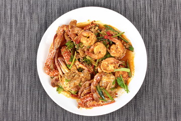 Stir-fried crab and shrimp in curry power is top-ten of popular Thai food as seafood to fried with  fresh milk ,grill curry ,egg ,oyster oil and yellow curry powder. 