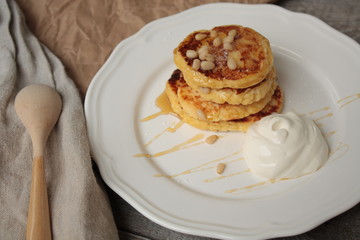 Russian sweet cheese pancakes with sour cream for Breakfast or a snack - it's delicious