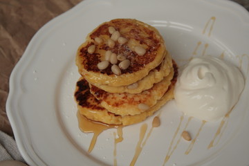 Russian sweet cheese pancakes with sour cream for Breakfast or a snack - it's delicious