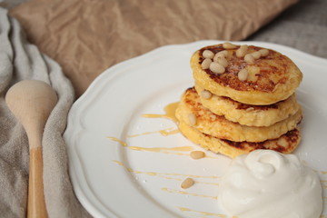 Russian sweet cheese pancakes with sour cream for Breakfast or a snack - it's delicious