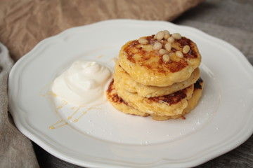 Russian sweet cheese pancakes with sour cream for Breakfast or a snack - it's delicious