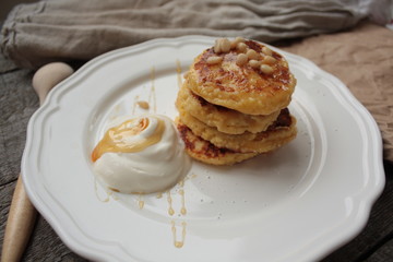 Russian sweet cheese pancakes with sour cream for Breakfast or a snack - it's delicious