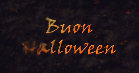 Buon Halloween text in Italian dissolving into dust to left.