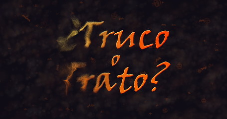 Truco o Trato (Trick or Treat) Spanish text dissolving into dust from left.