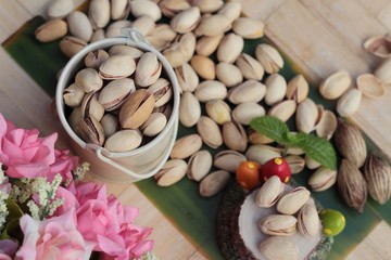 Pistachio nuts is tasty on wood background.