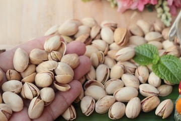 Pistachio nuts is tasty on wood background.