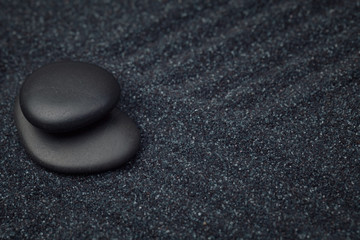 Fototapeta na wymiar Balance of black stones in a relaxing zen garden