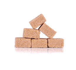 Brown cane sugar cubes isolated on white background.