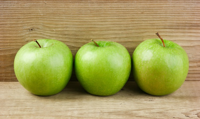 green apples on a wooden background