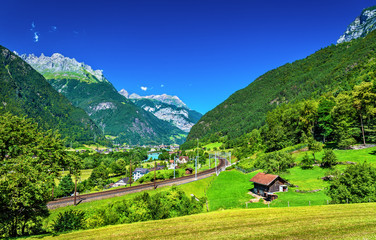 View of Erstfeld, a village in Swiss Alps - obrazy, fototapety, plakaty