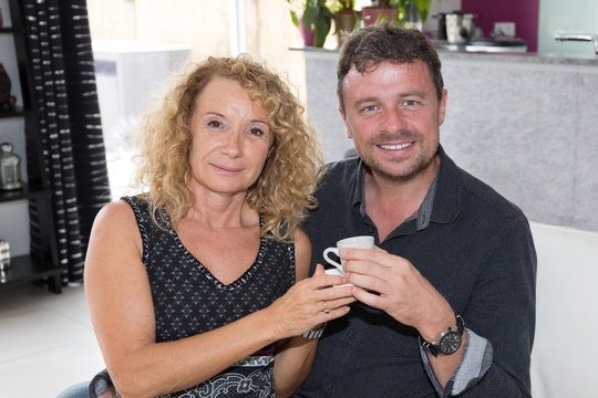 Man and woman drinking tea or coffee.