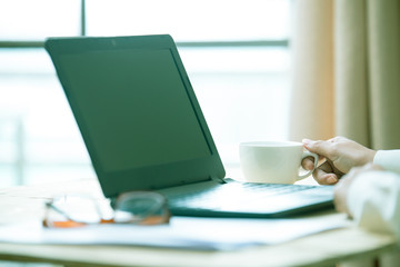 Business women hands working with laptop on wooden desk, lighting effect