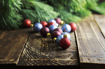 Christmas tree decorations on a wooden background with pine branches, selective focus