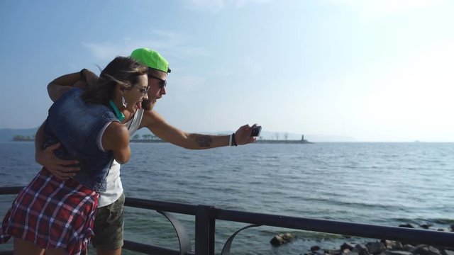 young couple taking selfi on vacation at the waterfront