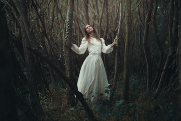 Young romantic woman in desolate forest