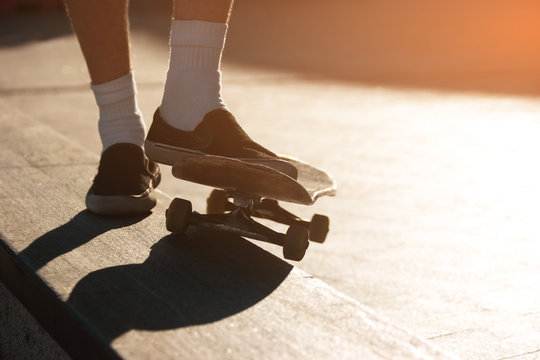Skateboard and feet. Legs in slip-ons. Have no fear of failures. Skills come with time.