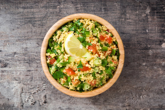 Tabbouleh salad with couscous on a rustic table


