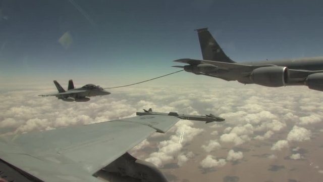 F/A-18 fighter jet refuels during flight.