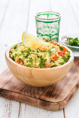 Tabbouleh salad with couscous on a white table

