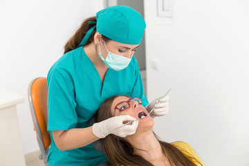 Obraz na płótnie Canvas Young woman patient at the dentist