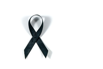 Black awareness ribbon isolated on white background. Mourning and melanoma symbol