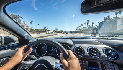 Man driving a sport car on Los angeles freeway