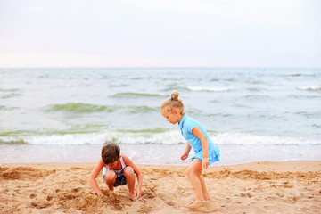 Fototapeta na wymiar two children playing on beach