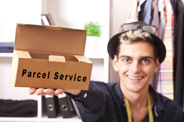 young man working with the package to send by courier