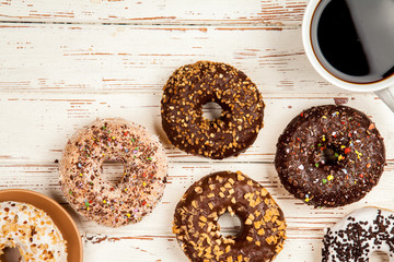 Tasty donuts on white wood background