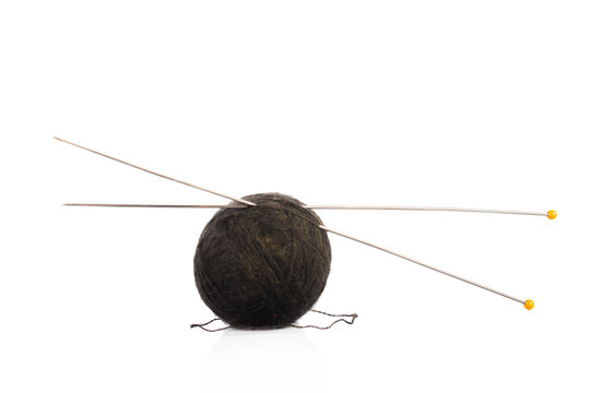 black ball of knitting yarn with spokes. On white, isolated background.