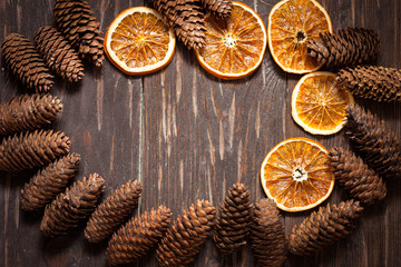 dark wood background with cones and dry orange  with copy space