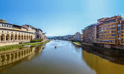 Fototapeta na wymiar Arno River in Florence, the view from Vecchio Bridge