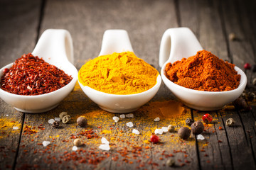 Spices. Spice in Wooden spoon. Herbs. Curry, Saffron, turmeric, cinnamon and other on a wooden rustic background. Pepper. Large collection of different spices and herbs. Salt, paprika.