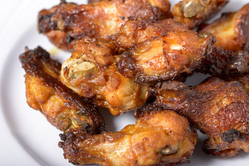 dish of spicy chicken wings on wood