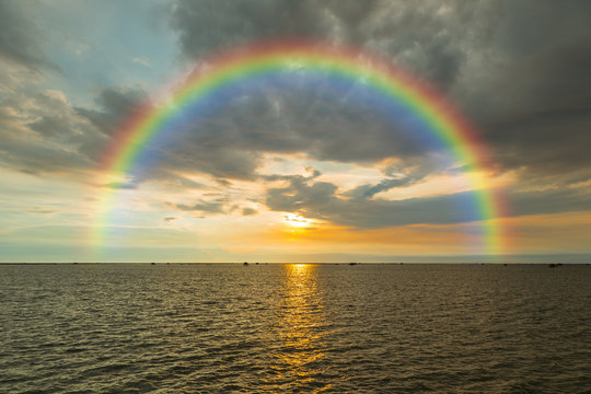 Fototapeta Seascape with rainbow during sunset