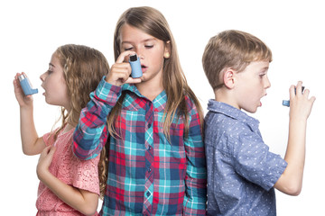 three childs using inhaler for asthma. White background