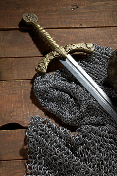sword and the soldier's helmet with horns on a wooden background