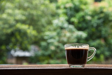Cup of coffee on nature background