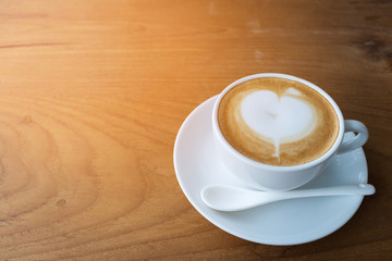 Top view coffee cup latte art on wood table.