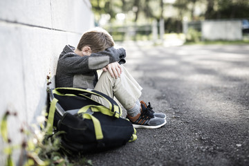 student boy outside at school standing