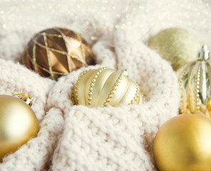 Fototapeta na wymiar Vintage festive golden Christmas globes in woolen blanket with l