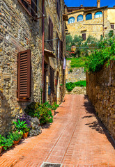 Old street in San Gimignano, Tuscany, Italy. San Gimignano is typical Tuscan medieval town in Italy