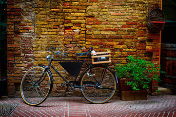 Old bike with wooden box on the street in San Gimignano, Italy