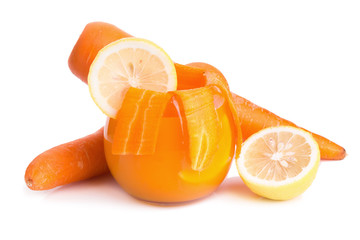 Glass of carrot and lemon juice on white background.