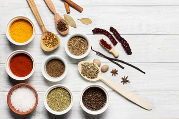 Spices on a white rustic wooden background, soft focus, horizontal