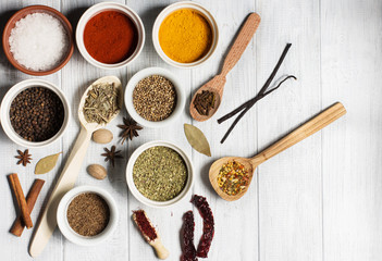 Spices on a white rustic wooden background, soft focus, horizontal